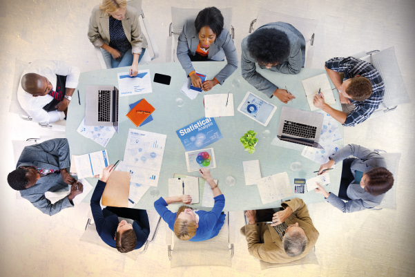 team round a table discussing other task to help with workflow