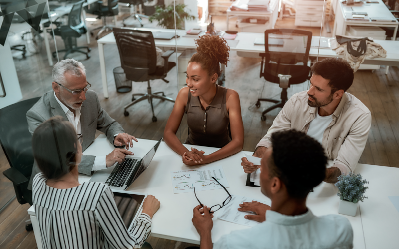 team around a table talking marketing strategy